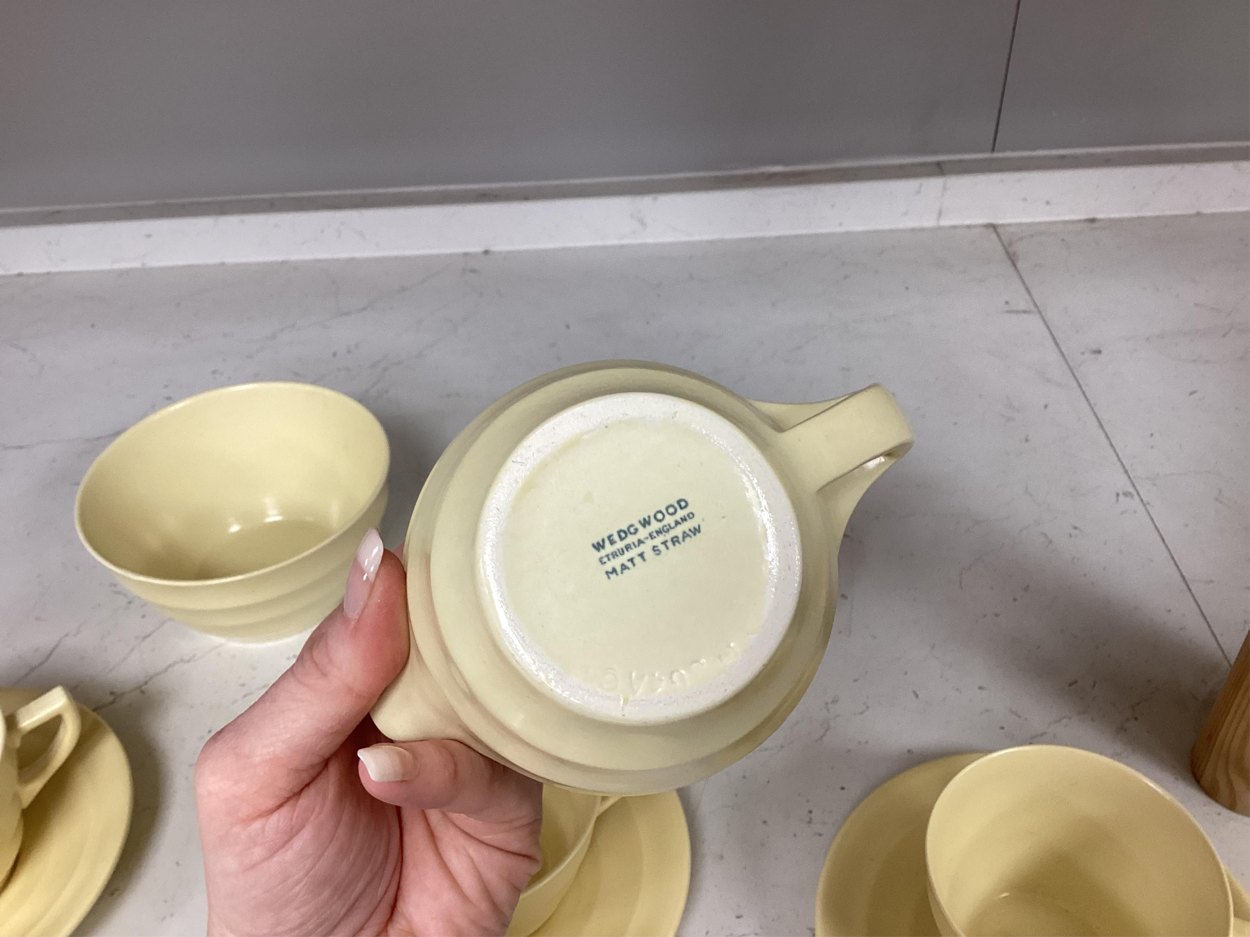 A part-set of Keith Murray Wedgwood teaware in matt straw, five cups and saucers, milk jug, sugar bowl and a spare saucer
